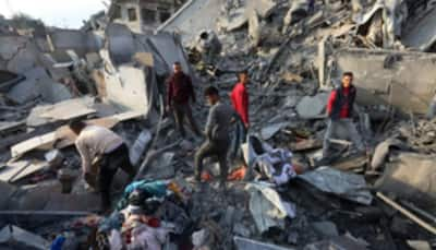 Palestinian Man Searches For Family Beneath Rubble After Israeli Strike Claims Dozens In Gaza