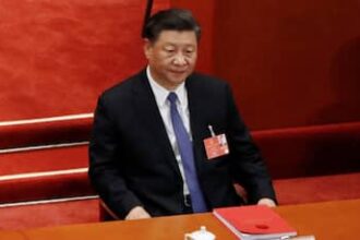 China Raises Flag On Disputed Reef Near Philippine Base, Escalating Tensions In South China Sea