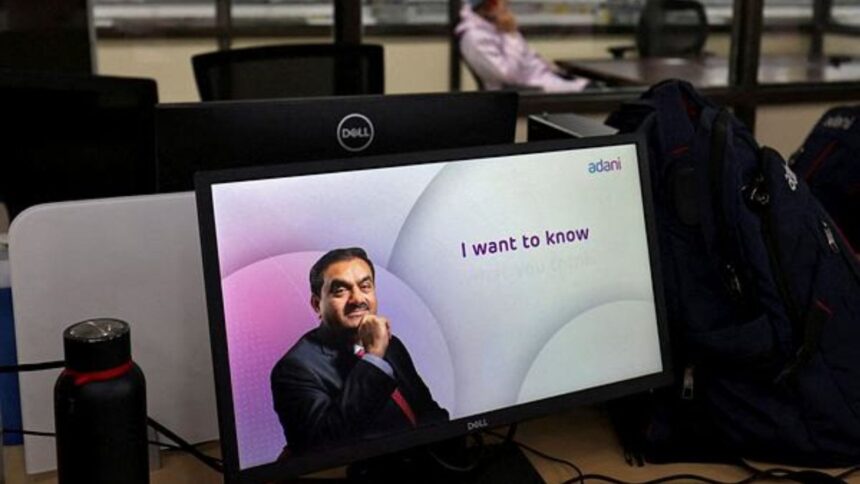 A technician talks on his cell phone at the Photovoltaic Modules assembling plant of Adani Green Energy Ltd, in Mundra. (Reuters File)