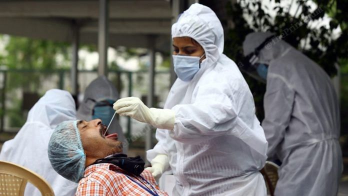 Representational Image | A medical worker collects sample for COVID-19 testing | Suraj Singh Bisht | ThePrint