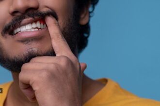 Dentists often respond to this concern with a quick fix: applying white composite fillings near the gum line