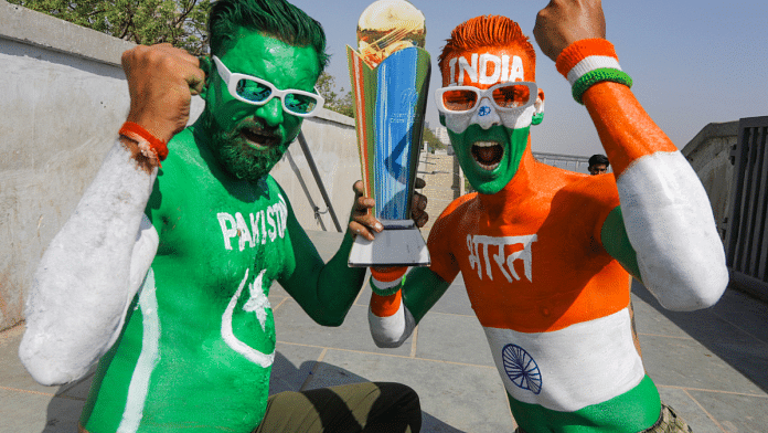 Cricket fans with their bodies painted in the colours of the Indian and Pakistani national flags pose for photographs ahead of the Champions Trophy 2025 match between India and Pakistan, in Ahmedabad, India, Feb. 23, 2025 | PTI