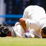 India's captain Virat Kohli kisses the field after scoring a double-century during day two of the first cricket Test match against West Indies at the Sir Vivian Richards Stadium in North Sound, Antigua, on July 22, 2016. (AP Photo)