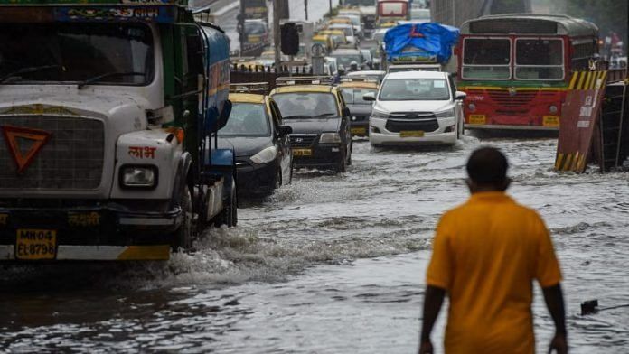 Vehicles drive through a waterlogged road after a heavy monsoon rainfall in Mumbai on 16 July, 2021 | Representational Image | Photographer: Punit Paranjpe/AFP/Getty Images via Bloomberg