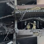 Firefighters work the scene of an explosion at a residence compound in northern Tehran