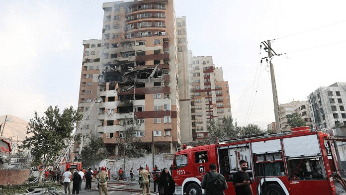 Firefighters work at the scene of a damaged building in the aftermath of Israeli strikes, in Tehran | Majid Asgaripour/WANA (West Asia News Agency) via REUTERS