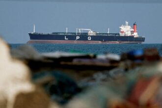 FILE PHOTO: An LPG gas tanker at anchor as traffic is down in the Strait of Hormuz, amid the U.S.-Israeli conflict with Iran, in Shinas, Oman, March 11, 2026. | REUTERS/Benoit Tessier/File Photo