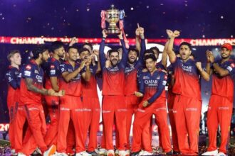 Virat Kohli of Royal Challengers Bengaluru lifts the IPL trophy alongside teammates following the team's victory in the 2025 IPL Final match at Narendra Modi Stadium in Ahmedabad, India on June 3. | Bloomberg