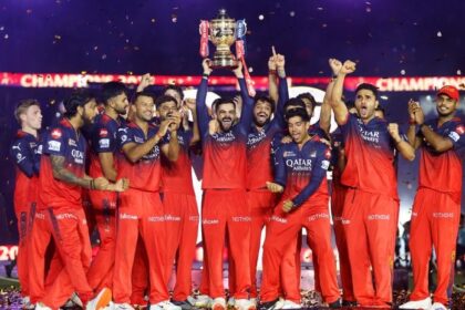 Virat Kohli of Royal Challengers Bengaluru lifts the IPL trophy alongside teammates following the team's victory in the 2025 IPL Final match at Narendra Modi Stadium in Ahmedabad, India on June 3. | Bloomberg