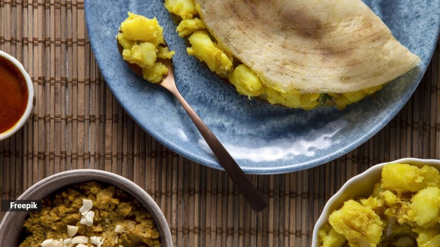 A freshly served plain dosa on a plate, a popular South Indian breakfast food
