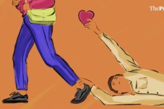 A man on the floor, holding the ankle of a woman with a heart in another, showing rejection in online dating