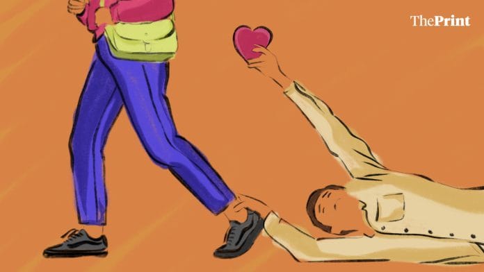 A man on the floor, holding the ankle of a woman with a heart in another, showing rejection in online dating