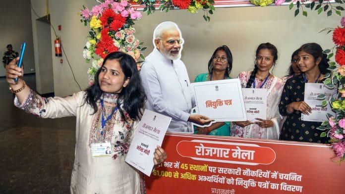 New joinees pose for photos with their appointment letters during a Rozgar Mela in Patna this January | Representational image | ANI