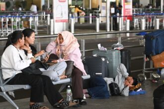 A group of passengers from Nepal is stranded at Chhatrapati Shivaji Maharaj International Airport terminal 2 as their flight to the middle east is cancelled due to the ongoing Iran-Israel conflict. (Express photo by Sankhadeep Banerjee)