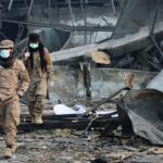 Taliban rescue workers inspect the site of a late-Monday airstrike at a drug rehabilitation hospital in Kabul, Afghanistan (AP Photo)