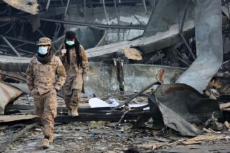 Taliban rescue workers inspect the site of a late-Monday airstrike at a drug rehabilitation hospital in Kabul, Afghanistan (AP Photo)