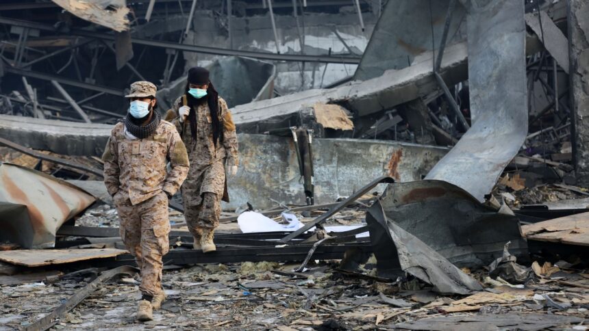 Taliban rescue workers inspect the site of a late-Monday airstrike at a drug rehabilitation hospital in Kabul, Afghanistan (AP Photo)