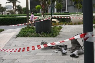 Debris lies on the sidewalk at the Address Creek Harbour hotel after it was hit by a drone strike overnight in Dubai, United Arab Emirates, Thursday, March 12, 2026. (AP Photo)