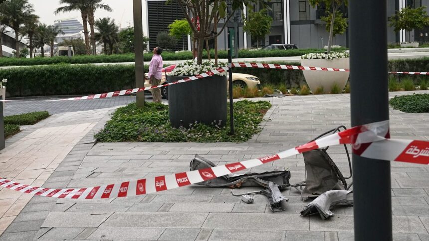 Debris lies on the sidewalk at the Address Creek Harbour hotel after it was hit by a drone strike overnight in Dubai, United Arab Emirates, Thursday, March 12, 2026. (AP Photo)