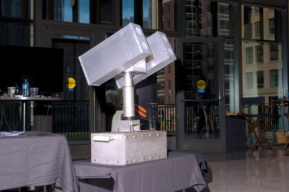 A high-energy laser called Archimedes developed by Aurelius Systems, on display during Reindustrialize, a manufacturing conference in Detroit, July 17, 2025. High-energy lasers that the US is using to counter drone attacks can burn them in the sky like a blowtorch, but they can be stymied by weather and making them at scale will be a challenge. (Credits: Nic Antaya)