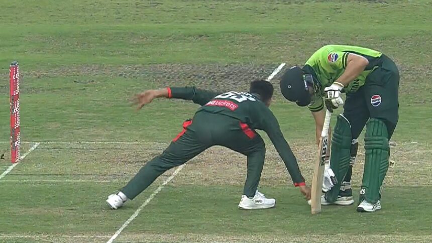Salman Ali Agha and Bangladesh captain Mehidy Hasan Miraz try to pick up the ball which Miraz got to first and then threw at the stumps to run out the Pakistan batter. (Screengrab via Fan Code)