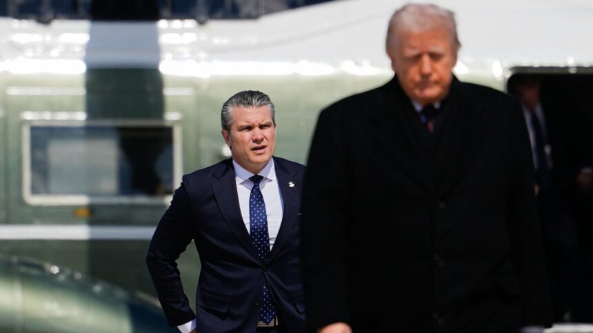Defense Secretary Pete Hegseth follows President Donald Trump to board Air Force One amid the war with Iran. (AP Photo)