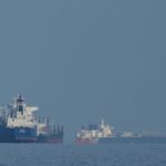 Oil tankers and cargo ships line up in the Strait of Hormuz as seen from Mina Al Fajer, United Arab Emirates, Wednesday, March 11, 2026. (AP Photo)