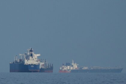 Oil tankers and cargo ships line up in the Strait of Hormuz as seen from Mina Al Fajer, United Arab Emirates, Wednesday, March 11, 2026. (AP Photo)