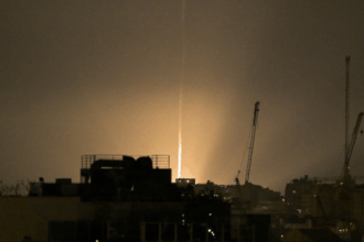 The sky is illuminated as an Iranian missile lands in Israel, amid the U.S.-Israeli conflict with Iran | Reuters/Dylan Martinez