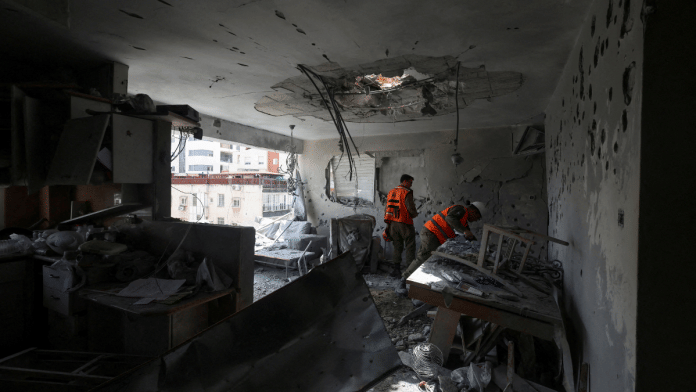 Soldiers inspect remains of an apartment struck in an Iranian missile attack in Ramat Gan, Israel on Wednesday. | Nir Elias/Reuters