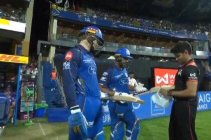 Rohit Sharma's bat is being checked by umpire