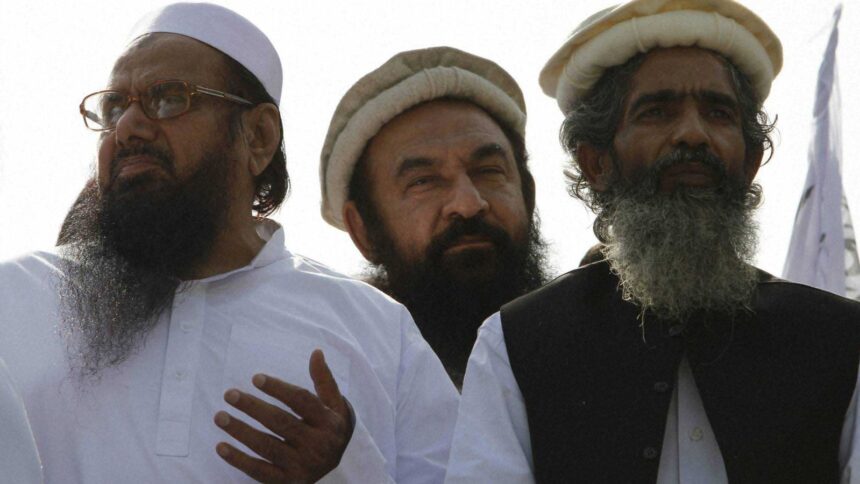 Maulana Amir Hamza (centre), a Lashkar-e-Taiba commander, was shot by unidentified assailants outside a news channel office in Lahore, Pakistan, on April 16. (AP/File)