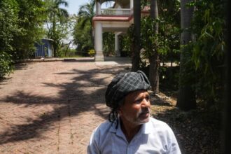 Along a shiny new expressway, a sole house and its lone caretaker are the face of an old fight