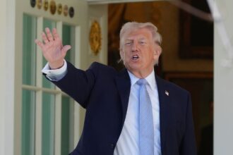 President Donald Trump gestures as he prepares to head back to the Oval Office after participating in the White House Easter Egg Roll on the South Lawn of the White House. (AP Photo)
