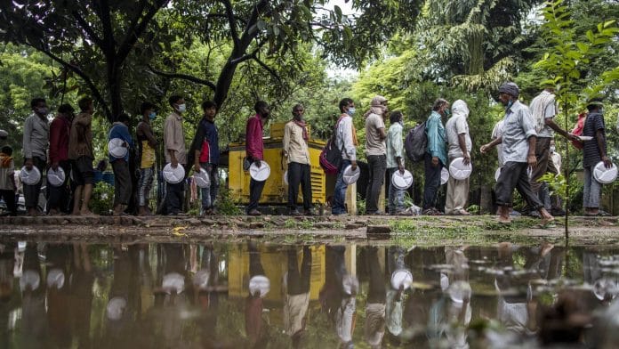 People line up to receive free meals distributed by volunteers in Lucknow on 10 June