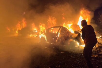 A firefighter extinguishes a car at the site of Israeli airstrikes, in Beirut, Lebanon. (AP Photo)