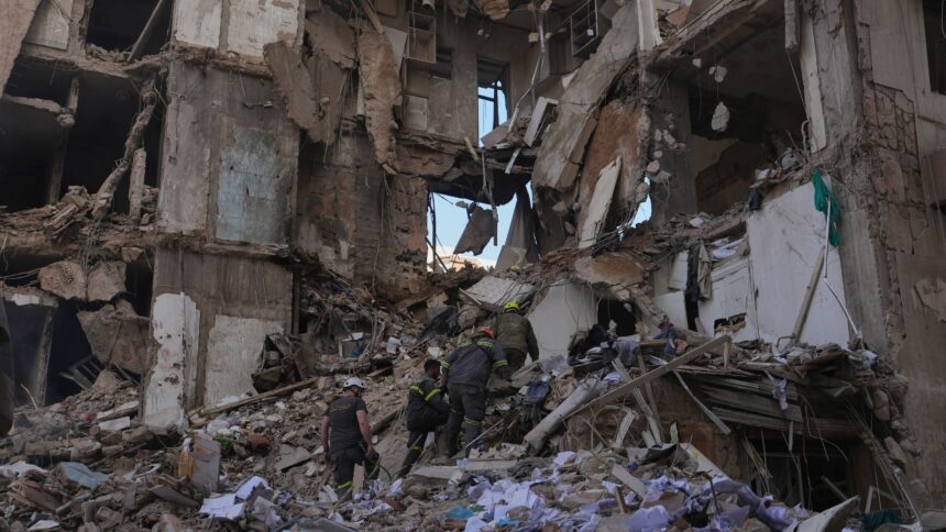 Lebanese civil defense workers search for victims in the rubble of a building destroyed in an Israeli airstrike a day earlier in central Beirut, Lebanon. (AP Photo)