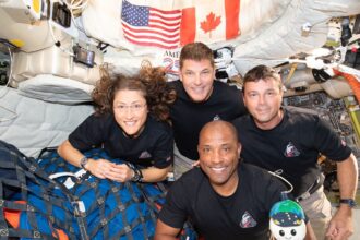 The crew of the Artemis II mission, clockwise from left: Mission Specialist Christina Koch, Mission Specialist and Canadian Space Agency astronaut Jeremy Hansen, Mission Commander Reid Wiseman and Pilot Victor Glover pose for a group photo with their zero gravity indicator ÒRiseÓ inside the Orion spacecraft on April 7, 2026. The crew members are scheduled to splash down off the coast of San Diego