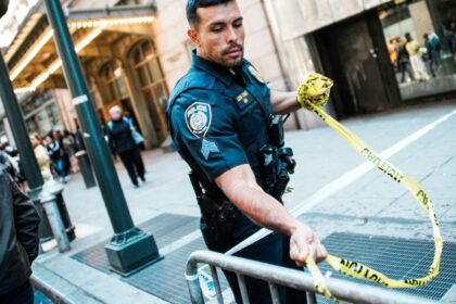 An NYPD officer removes police tape outside Grand Central subway station in New York City on April 11. (Reuters)