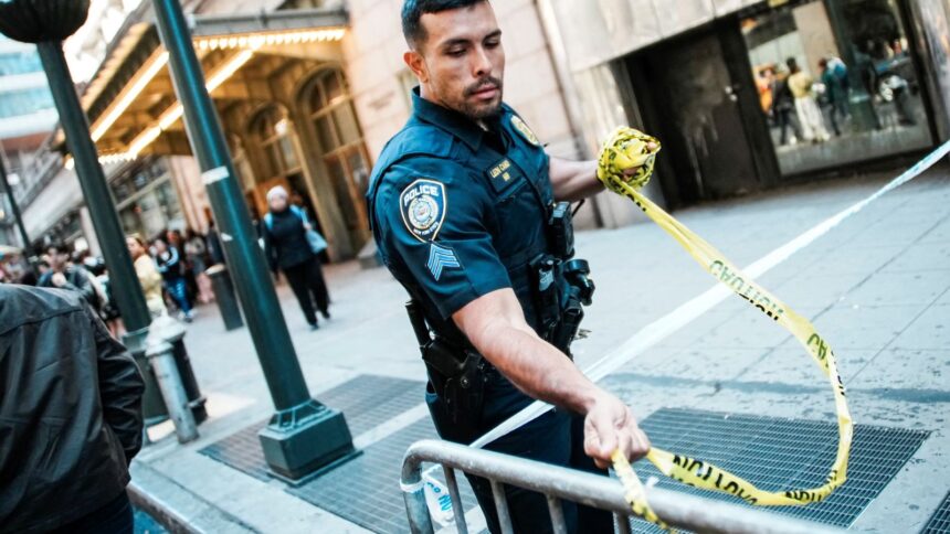An NYPD officer removes police tape outside Grand Central subway station in New York City on April 11. (Reuters)