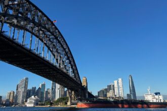 The oil and chemical tanker Forever Conviviality sails under the Sydney Harbour Bridge as it leaves Sydney