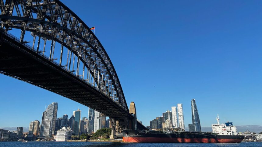 The oil and chemical tanker Forever Conviviality sails under the Sydney Harbour Bridge as it leaves Sydney