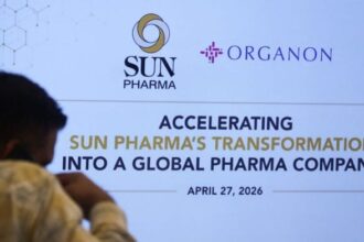 A man walks past a screen during a press conference announcing Sun Pharma's acquisition of Organon in Mumbai, on 27 April 2026 | Francis Mascarenhas/Reuters