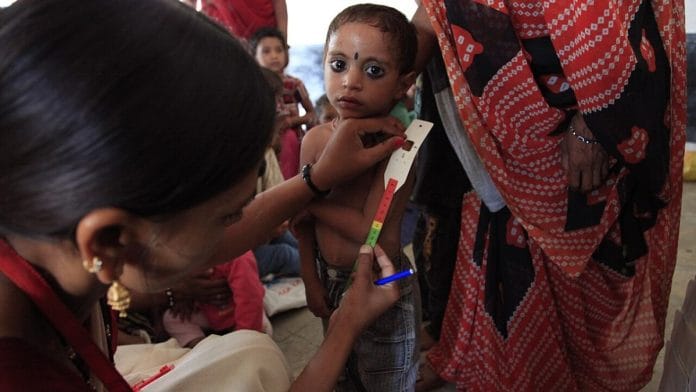File photo of a child’s upper arm being measured at an Anganwadi centre in Madhya Pradesh’s Dhar district to check for malnutrition. | Commons