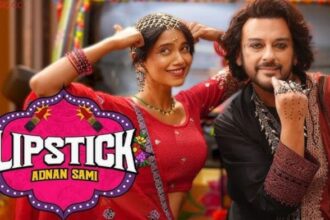In the music video, singer Adnan Sami appears in an all-black outfit, with curly hair and silver jewellery alongside actor Bhagyashree Limaye | Source: YouTube, Zee Music Company