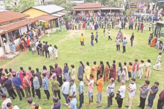 People wait in a queue to cast their vote at Latakata polling station during the Assam Legislative Assembly elections on April 9. (ANI Photo)