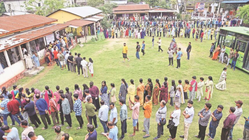 People wait in a queue to cast their vote at Latakata polling station during the Assam Legislative Assembly elections on April 9. (ANI Photo)