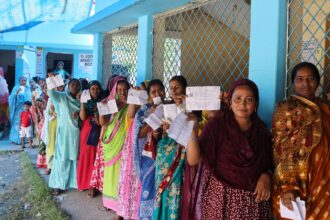 Voters queue outside Bahirpua Kurkuria F.P. School polling station under the Magrahat Paschim Assembly constituency of South 24 Parganas district. (Express photo by Partha Paul)