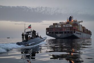 In this photo released by Tasnim News Agency, a Revolutionary Guard Navy (IRGC) speedboat approaches the cargo ship Epaminondas during what state media described as the seizure of one of two vessels accused of violations in the Strait of Hormuz. Iran (AP Photo)