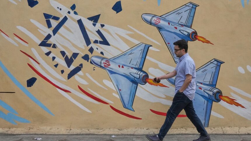 A man walks past an anti-Israel mural in downtown Tehran, Iran, Sunday, May 17, 2026. (AP Photo/Vahid Salemi)